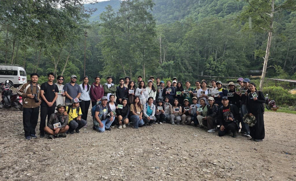 Greenalaya Nepal team with butterfly research materials outdoors